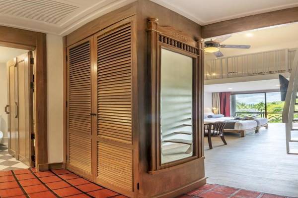 Zimmer im Chada Thai Village Resort mit rotem Boden und Holzschrank