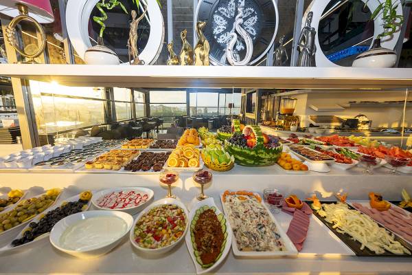 Ein Buffet im Arden City Hotel mit verschiedenen Gerichten und Früchten.