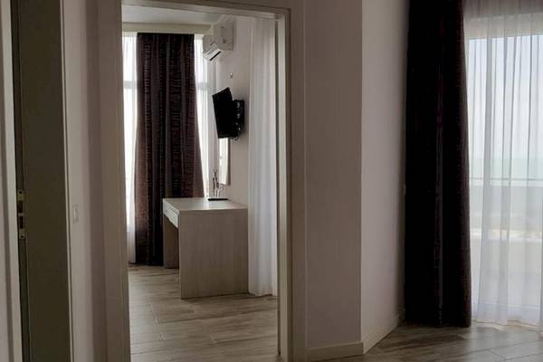 Innenansicht eines Hotelzimmers im Klajdi Resort & SPA, mit Schreibtisch, Fernseher und Spiegel.