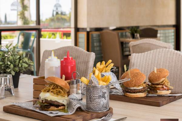 Restauranttisch im Ukino Terrace Algarve mit Burgern, Pommes und Beilagen
