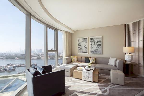 Wohnbereich im Al Bandar Rotana Hotel mit Blick auf die Stadt und den Hafen