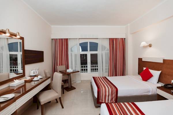 Doppelzimmer im Golden Beach Resort mit zwei Betten, Schreibtisch und Aussichtsfenster.