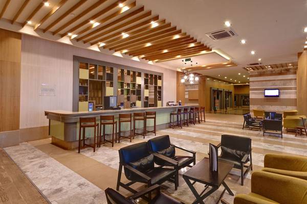 Innenbereich der Lobby im Sherwood Dreams Resort mit Bar, Stühlen und Tisch.