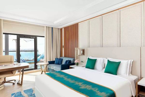 Taj Exotica Resort & Spa Suite Zimmer mit Blick auf das Meer und modernen Möbeln.