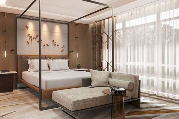 Schlafzimmer im Gloria Serenity Resort mit einem großen Bett und einer Chaiselongue.