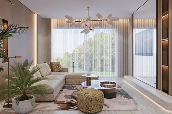 Hotellounge Bereich im Gloria Serenity Resort mit modernem Interieur, großer Couch, Pflanzen und Panoramafenstern.