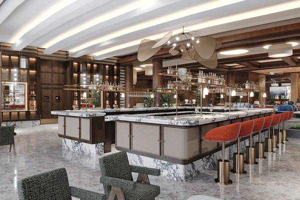 Innenansicht der Bar im Gloria Serenity Resort mit Marmortheke und roten Stühlen.