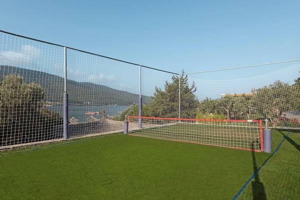 Fussballfeld mit Netz im Freien neben einem Hotel am Meer