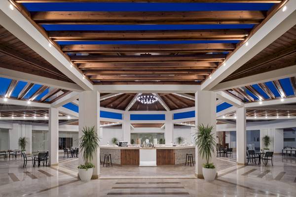 Innenansicht der Lobby des Xanadu Makadi Bay Hotels mit Holzdecken und Tischen.