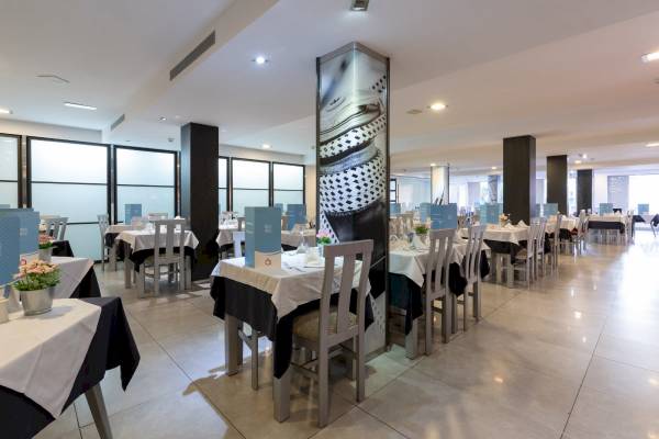 Innenansicht des Restaurants im Nautic Hotel & Spa mit gedeckten Tischen und Stühlen.
