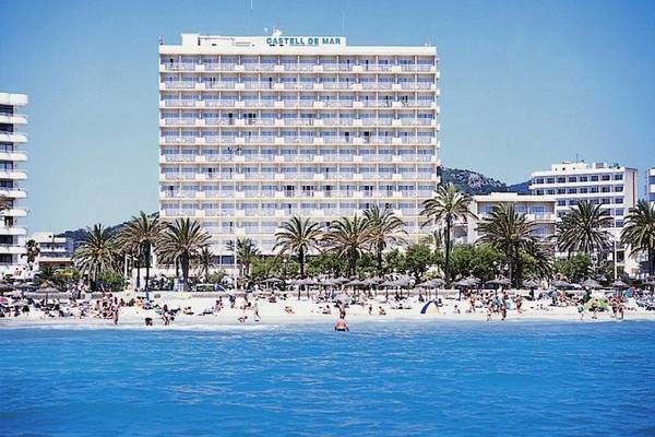 Außenansicht des CM Castell de Mar Hotels am Strand mit vielen Gästen und Palmen.