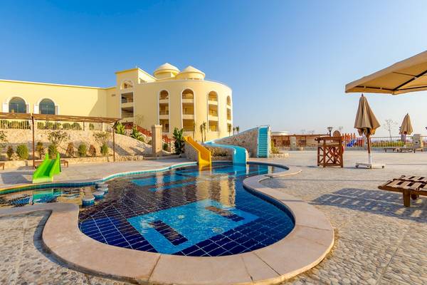 Außenpoolbereich des Siva Golden Bay Makadi Hotels mit Wasserrutschen und Sonnenschirmen.