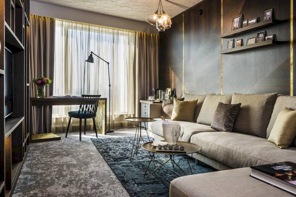 Wohnzimmer des Novotel London Canary Wharf mit Sofa, Tisch und Lampen.