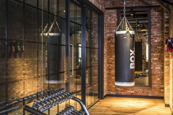 Fitnessraum im Novotel London Canary Wharf mit Boxsäcken und Hanteln.