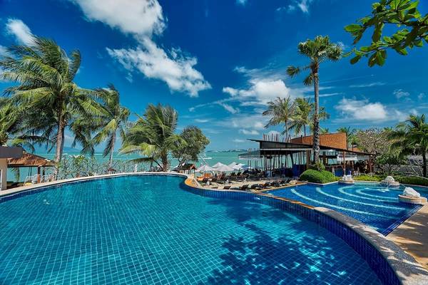 Außenpool im Bandara Resort & Spa, Samui mit Sonnenliegen und Palmen.