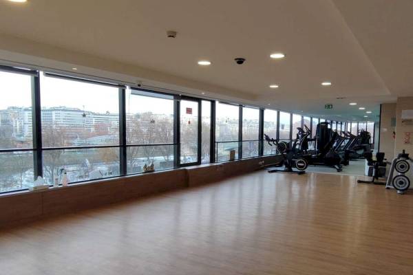 Fitnessraum im Novotel Paris Tour Eiffel mit Blick auf die Stadt.