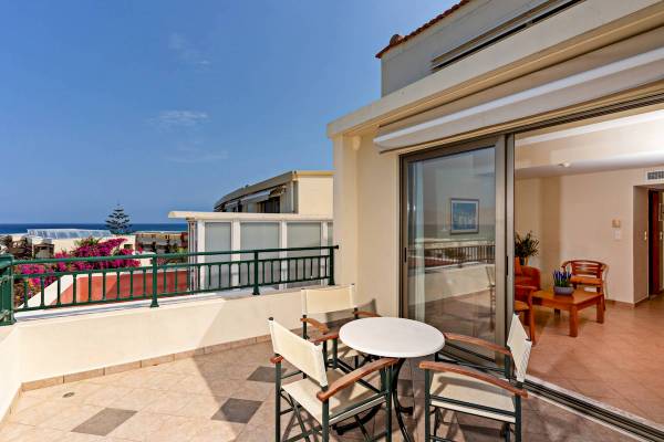 Balkon des Hydramis Palace Beach Resort mit Blick auf das Meer und grünen Pflanzen