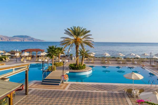 Außenbereich des Hydramis Palace Beach Resort mit Pool, Palmen und Blick aufs Meer