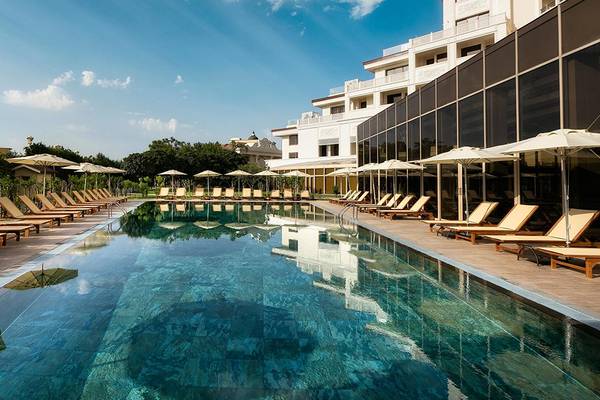 Außenpool des Titanic Mardan Palace Hotels mit Loungeliegen und Sonnenschirmen