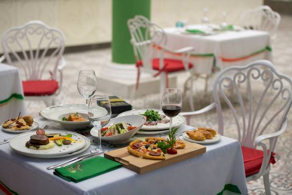 Gedeckter Speisetisch im Sentido Kamelya Fulya Hotel mit verschiedenen Gerichten und Weingläsern.