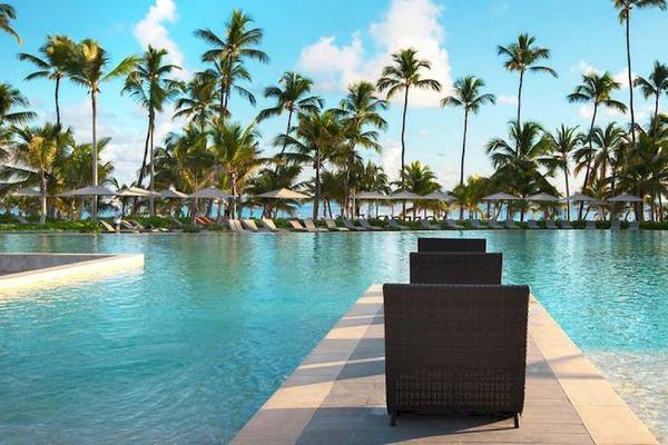 Außenpool des Lopesan Costa Bavaro Resort Spa & Casino mit Palmen und Sonnenliegen