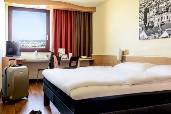 Hotelzimmer im Ibis Wien Mariahilf mit Bett, Fenster und Stadtblick