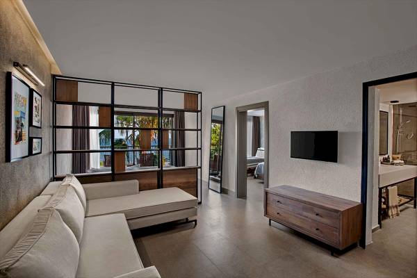 Club Marvy Hotel Suite Wohnzimmer mit Sofa, Fernseher und Fenstern