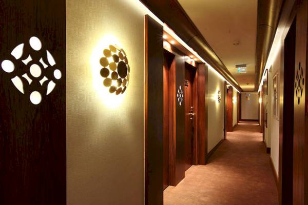 Korridor des Victory Hotel & Spa Istanbul mit heller Beleuchtung und Holztüren.
