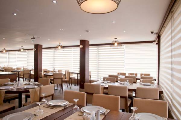 Innenansicht des Restaurants im Victory Hotel & Spa Istanbul mit gedeckten Tischen und Stühlen.