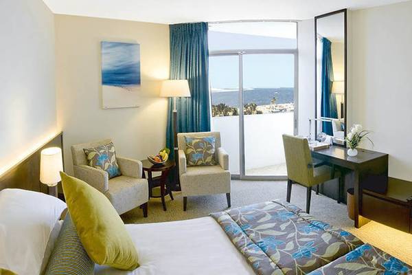 Suite Zimmer im JA Beach Hotel mit Blick auf das Meer und die Insel.