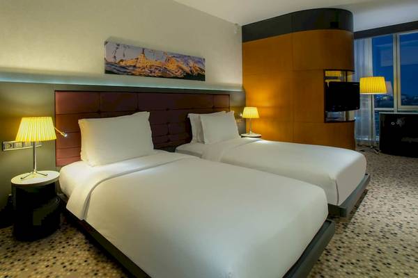 Doppelzimmer im Doubletree by Hilton Istanbul Moda mit zwei Betten, Lampen und Stadtblick