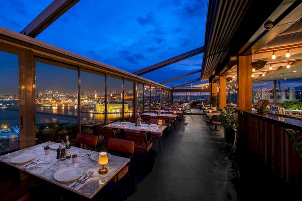 Abendansicht des Restaurants im Doubletree by Hilton Istanbul Moda mit Blick auf die Stadt