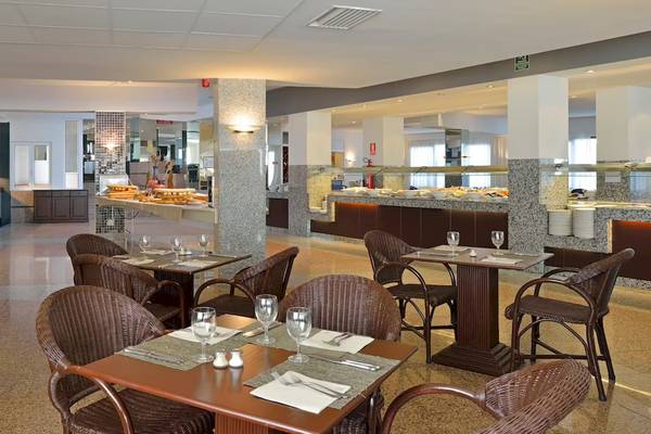 Innenbereich des Restaurants im Sol Milanos Pinguinos Hotel mit Tischen, Stühlen und Essensbereich
