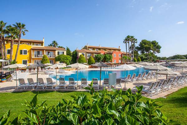 Außenbereich des Grupotel Playa Club mit Swimmingpool und Sonnenliegen