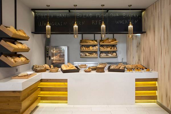 Bäckerei-Display im Agapi Beach Resort mit frischem Brot und einer Tafel mit 'FRESH BAKED BREAD FROM OUR BAKERY'.