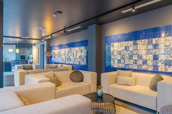 Loungbereich des Sentido Galosol Hotels mit weißen Sofas und blauen Wandfliesen.