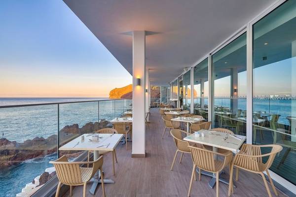 Terrasse des Sentido Galosol Hotels mit Blick auf den Sonnenuntergang über dem Meer.