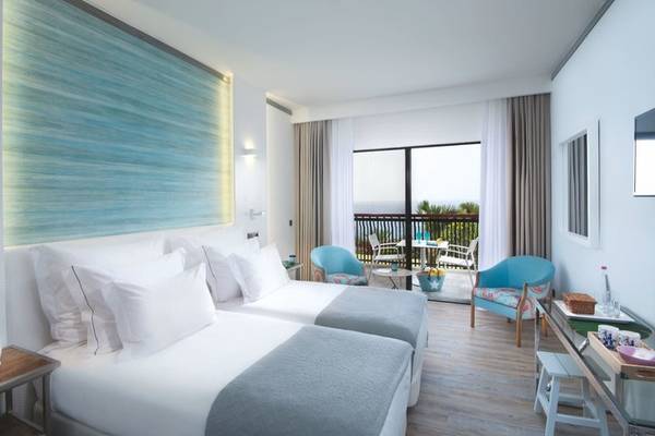 Zimmer im Baia Azul Hotel mit Blick auf das Meer und eine Terrasse.