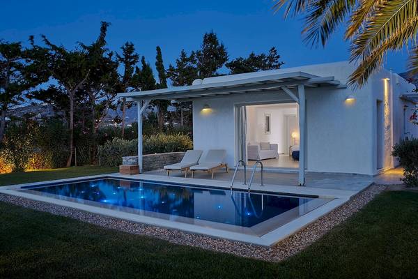 Außenbereich des Yria Island Boutique Hotel & Spa bei Nacht mit Pool und Loungemöbeln.