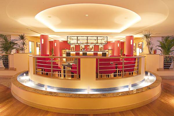 Loungebereich im Pestana Grand Premium Ocean Resort mit roter Bestuhlung und Wasserbrunnen.