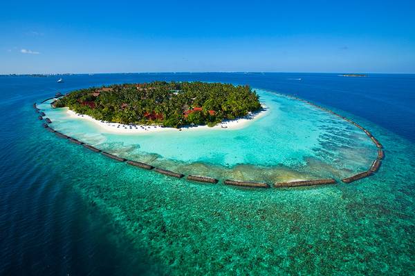 Luftaufnahme der Kurumba Maldives Insel mit klarem blauem Wasser und weißen Stränden.
