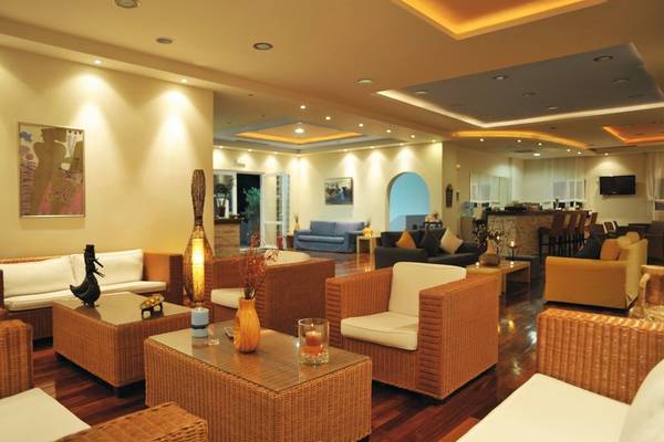 Lobby des Naftilos Boutique Hotel mit Sofas, Tischen und Dekor.