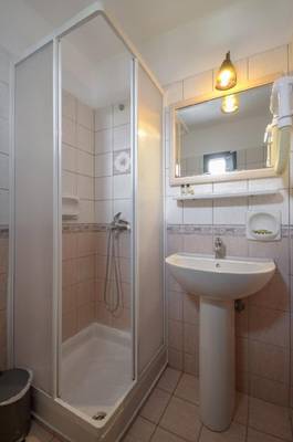 Badezimmer mit Duschkabine und Waschbecken im Naxos Resort Beach Hotel
