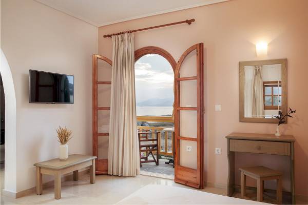 Innenansicht einer Suite im Proteas Hotel mit Blick auf einen Balkon und das Meer.