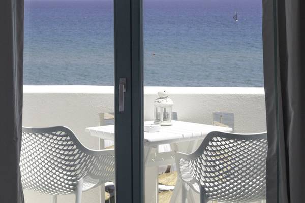 Blick vom Balkon des Amaryllis Paros Beach Hotels auf das Meer mit Segelboot im Hintergrund.