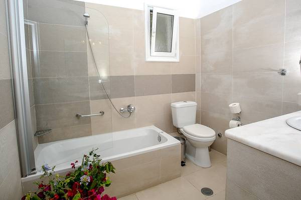 Ein Badezimmer mit einer Badewanne, Dusche, Toilette und Waschbecken.