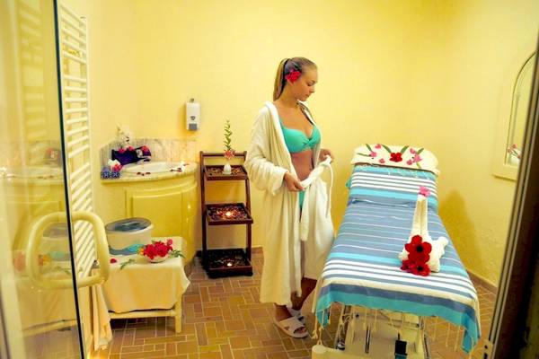 Spa-Behandlungsraum im Lella Baya & Thalasso Hotel mit einer Frau im Bademantel.