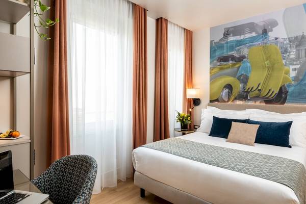 Doppelbettzimmer im Leonardo Boutique Hotel Rome Termini mit gelbem Roller Wandbild.