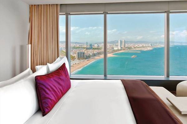 Ein elegantes Zimmer im W Barcelona Hotel mit Panoramablick auf die Stadt und das Meer.