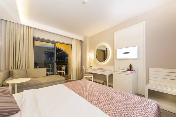 Suite-Zimmer im Diamond Premium Hotel & Spa mit Bett, Schreibtisch, Fernseher und Balkon.